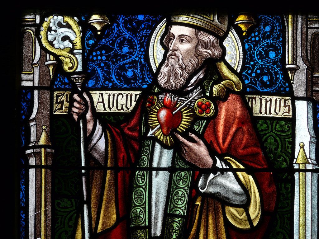 St. Augustine in stained glass, bishop and doctor of the Church, with the flaming heart symbolizing love for God